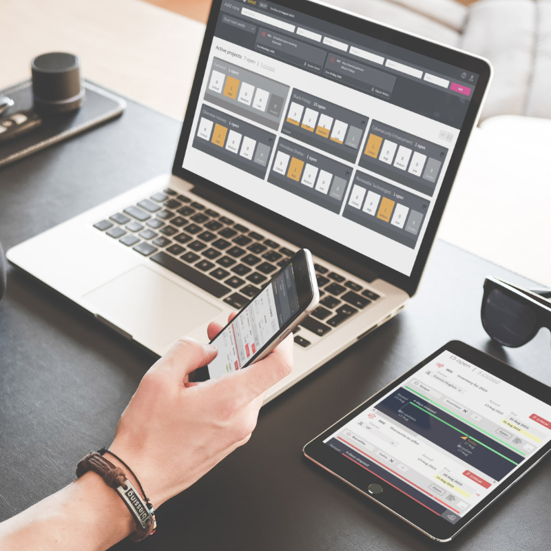 Image of project manager accessing Sympmy Beat on multiple devices
